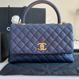 CHANEL top handle quilted bag in navy with matte gold hardware.